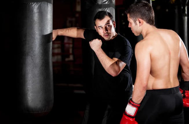Martial arts coach training student in Boxing 