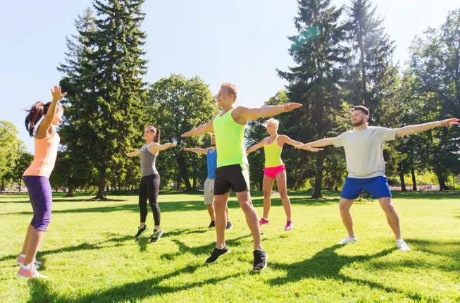 Group fitness training in a park