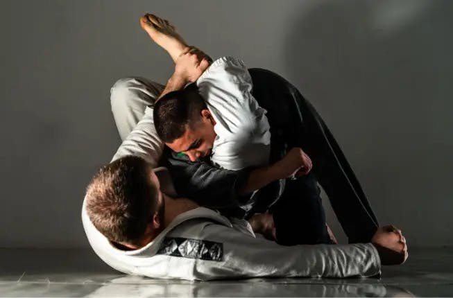 Two men training martial arts, Brazilian Jiu Jitsu grappling 