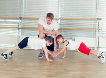 Kids Training Martial Arts with coach in a gym 